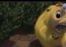 a close up of a yellow cartoon character with its mouth open .