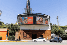 a billboard for alice connors is above a building