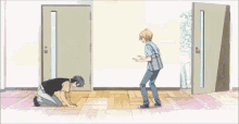 a man is kneeling down in front of a door while another man stands in front of it .