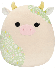 a stuffed animal that looks like a cow has a pink nose