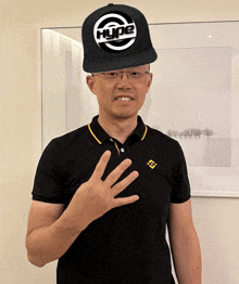 a man wearing a black hype hat and a black shirt