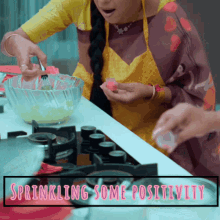 a woman in an apron is sprinkled with pink icing