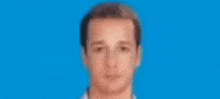 a blurry picture of a man 's face on a blue background .