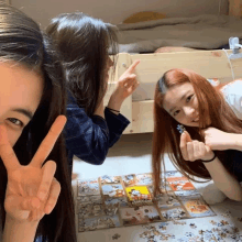 three girls are posing for a picture in front of a puzzle that says disney on it