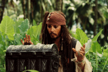 a man with dreadlocks and a bandana on his head is looking into a treasure chest