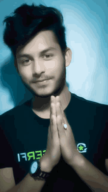 a young man wearing a black shirt that says rebel