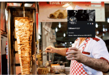 a man is cooking food in front of a sign that says tavuk dorce