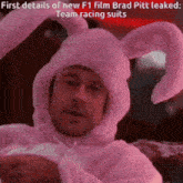 a man in a pink bunny suit is holding a remote control