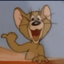 a close up of jerry from tom and jerry waving his hand .