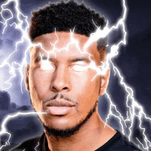 a man 's face is lit up with lightning bolts