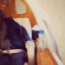 a person is sitting in an airplane with a bottle of water on the arm rest