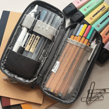 a pencil case filled with lots of pens and markers including stabilo boss