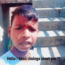 a young boy with a sad look on his face is standing in front of some stairs and says hello !