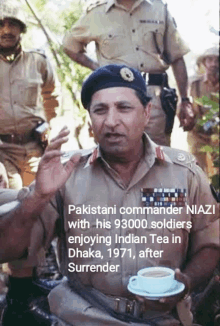 a man in military uniform is holding a cup of tea