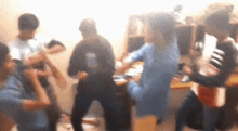 a group of young people are dancing in a room .