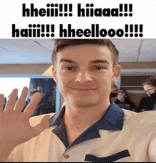 a man in a white and blue shirt waves his hand in front of a sign that says ' hheiiii ' on it