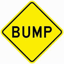 a yellow diamond shaped sign with the word bump written on it .