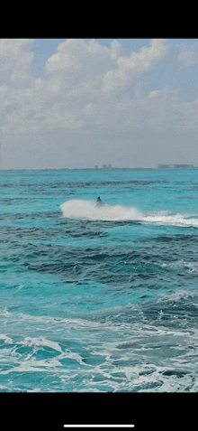 a person is riding a jet ski on the ocean