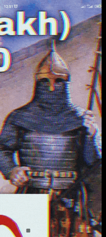 a phone screen shows a knight holding a sword and the time 12:51