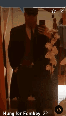 a man in a suit is taking a picture of himself in the mirror