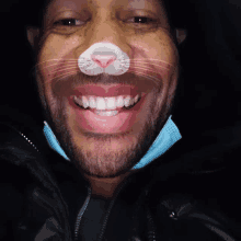 a man with a cat nose is smiling and wearing a face mask