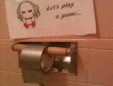 a roll of toilet paper with a sign that says " let 's play a game "