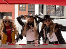 three women standing next to each other wearing shirts that say die