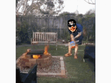 a man in a clown mask stands in front of a fire pit with the words purification written on it