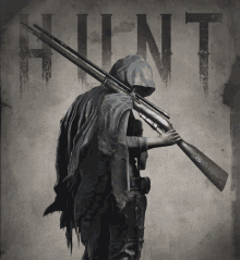 a man in a hooded cape is holding a gun in front of a hunt sign