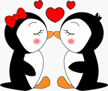 a couple of penguins are kissing each other with hearts behind them .