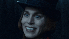 a close up of a person wearing a top hat smiling