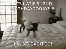 a baby is jumping on a bed with the words `` it 's katie 's 22nd birthday today !!! ''