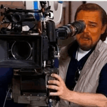 a man is holding a camera in front of his eyes