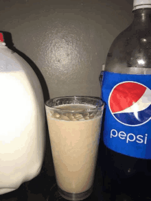 a bottle of pepsi next to a glass of pepsi