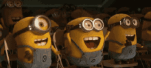 a group of minions wearing goggles and overalls are sitting in a classroom