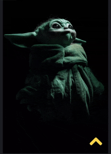 a picture of a baby yoda on a black background