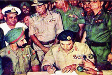 a group of men in military uniforms are signing papers