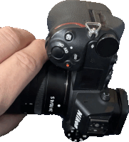 a nikon camera is being held by someone