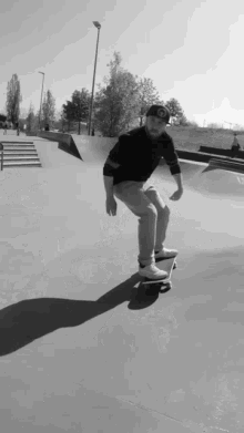 a man is riding a skateboard in a black and white photo with a hat that has the letter o on it