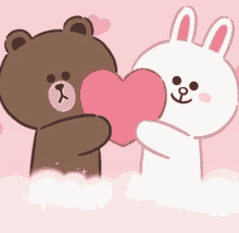 a brown bear and a white rabbit are holding a heart together