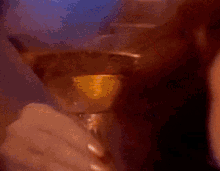 a blurred image of a person holding a wine glass