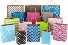 a bunch of different colored bags with handles on a white background