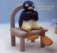 a stuffed penguin is sitting on a chair with the words well now i am not going to do it