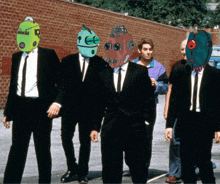 a group of men in suits and ties standing next to each other with cartoon faces on their heads