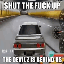 a car is driving down a road in a video game and says `` shut the fuck up the devil is behind us ''