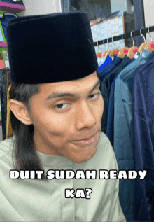 a man wearing a black hat says duit sudah ready ka?