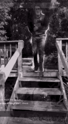 a man is walking up a set of stairs .