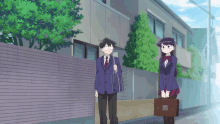 a boy and a girl are standing next to each other on a sidewalk