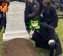 a man kneeling in front of a gravestone that says oliver queen 1985-2019