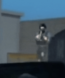 a blurry picture of a man with a gun in a video game .